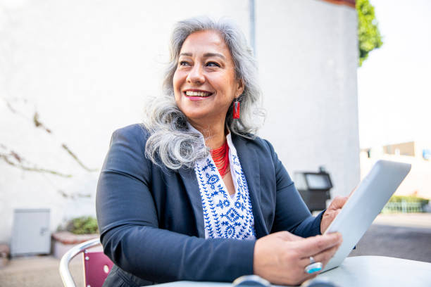 Latina Businesswoman Using Tablet at Cafe