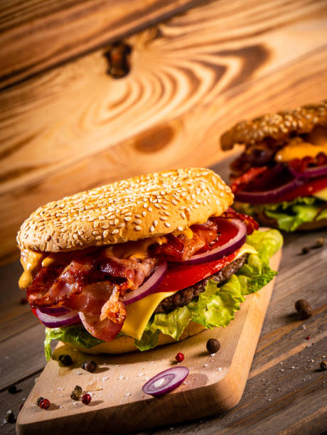 istock Bacon burger with beef patty on wooden table 1188966876