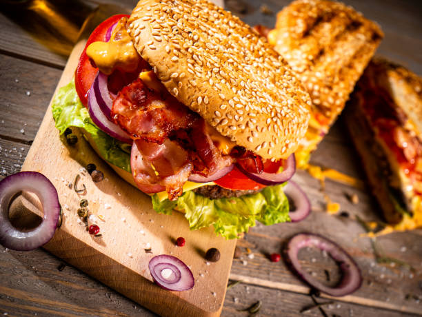 istock Bacon burger with beef patty on wooden table 1188967893
