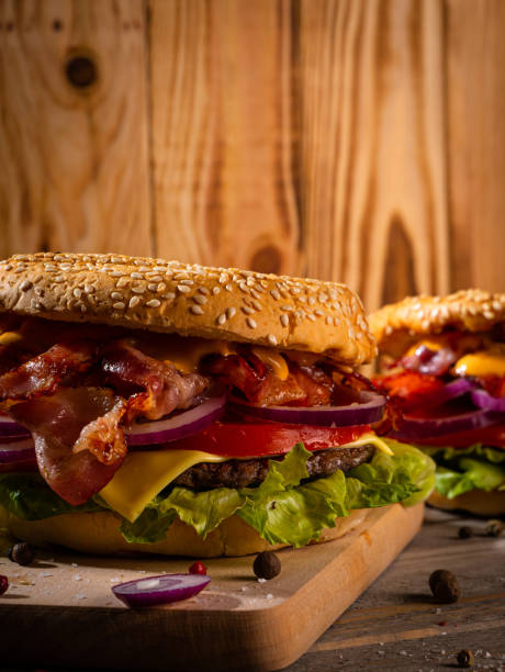 istock Bacon burger with beef patty on wooden table 1188968502