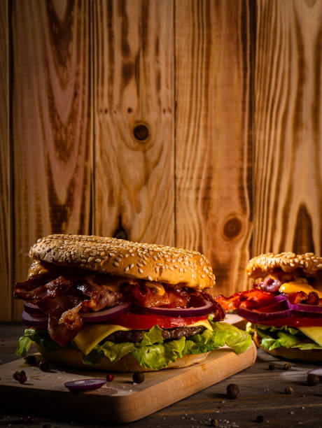 istock Bacon burger with beef patty on wooden table 1188968549