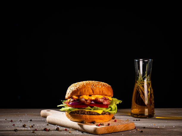 istock Bacon burger with beef patty on wooden table 1188968594