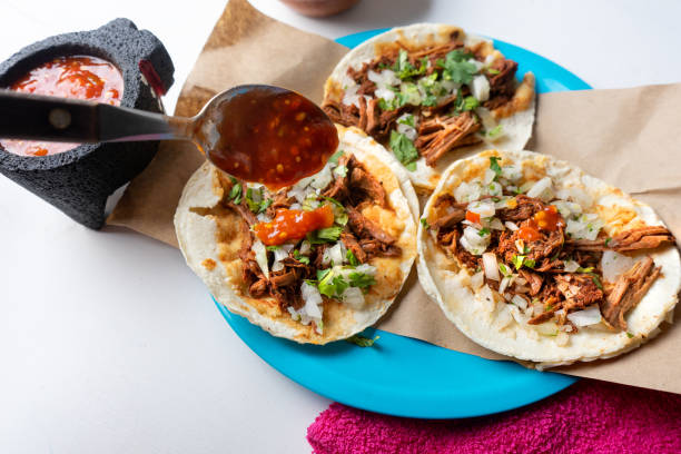istock Mexican birria tacos with onion and cilantro on white background 1188968954