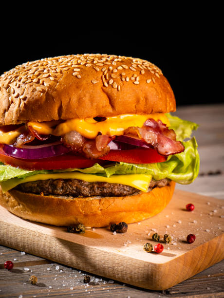 istock Bacon burger with beef patty on wooden table 1188968971