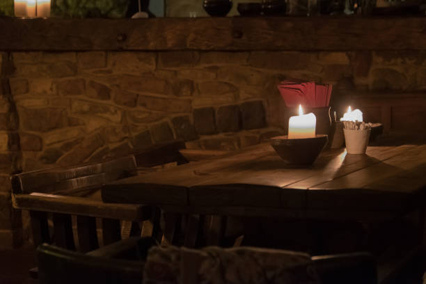 istock Big candle in a plate on a wooden table 1188969129