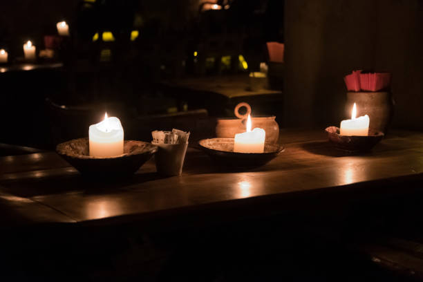 istock Big candle in a plate on a wooden table 1188969309