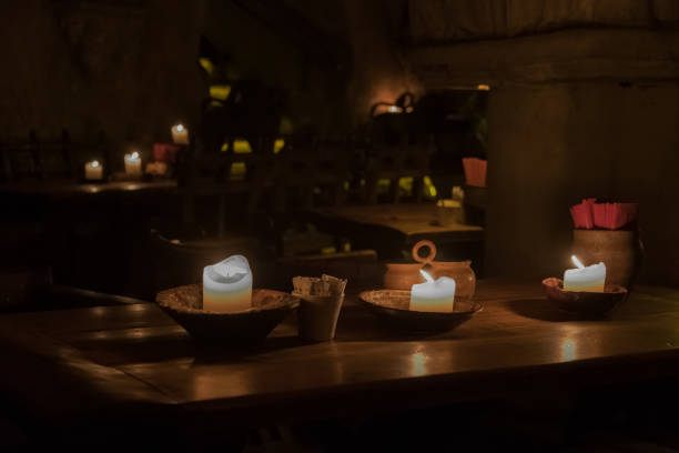 istock Big candle in a plate on a wooden table 1188969314