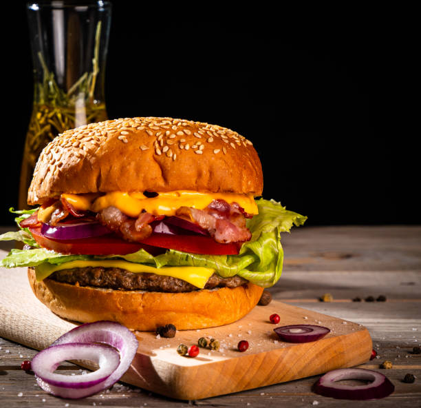 istock Bacon burger with beef patty on wooden table 1188969880