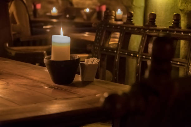 istock Big candle in a plate on a wooden table 1188970039