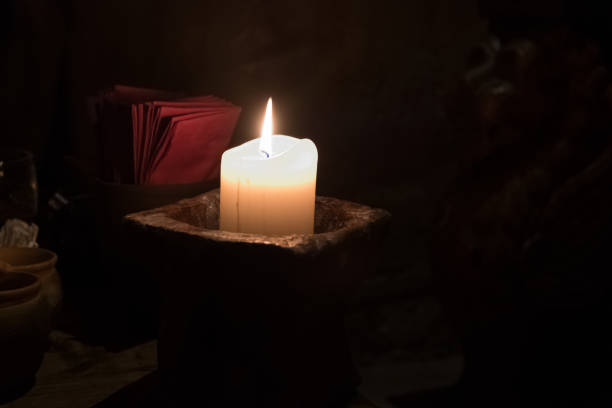 istock Big candle in a plate on a wooden table 1188970041