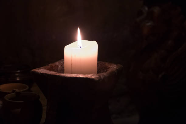 istock Big candle in a plate on a wooden table 1188970925