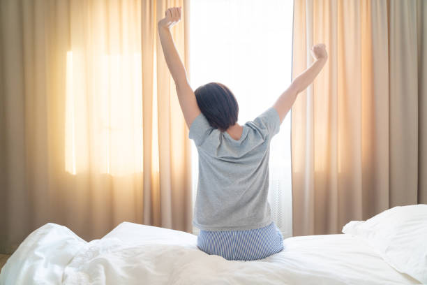 istock Woman stretching in cozy bed after good dreams 1188972002