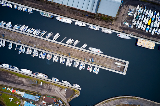 Aerial view of Marina with boats and yachts from above in row and pontoon uk