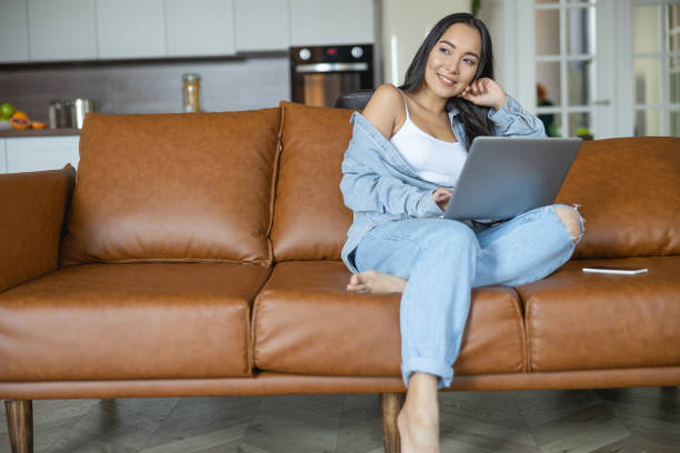 istock Dreamy girl with a gadget looking away 1188976144