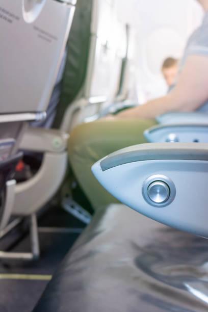 istock Close Up of Armrest inside an Airplane during Flight on Blurred Background 1188977468