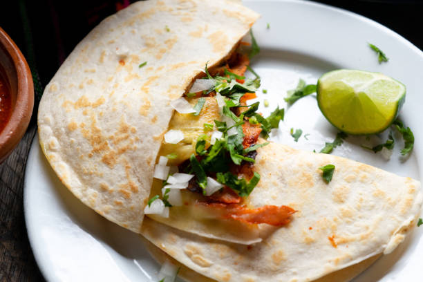 Mexican quesadilla with pork also called "gringa al pastor" Traditional mexican quesadilla with pork also called "gringa al pastor" fresh cilantro stock pictures, royalty-free photos & images