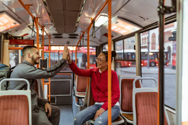 istock Smiling multicultural couple sitting on the city bus 1188990048