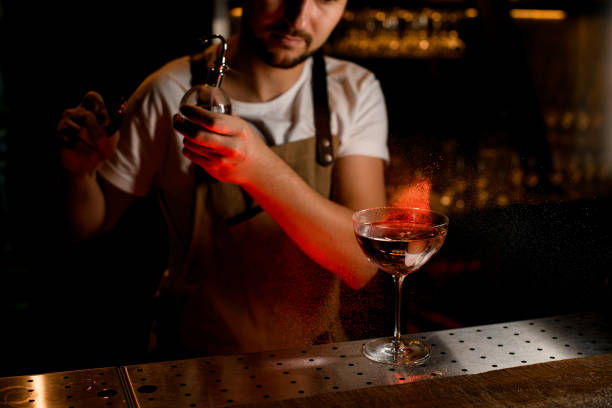 istock Professional bartender spraying on the cocktail in the glass with a bitter 1188992183