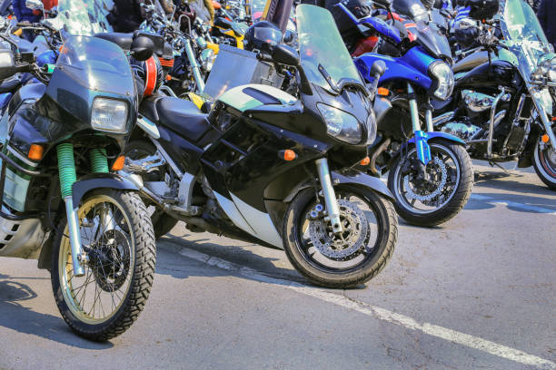 multiple motorbikes lined up in a parking lot