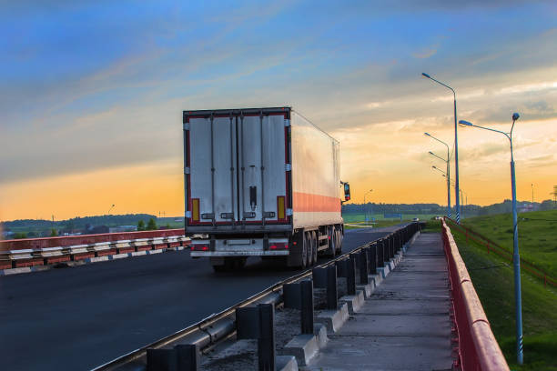 istock truck goes on highway on sunset 1188993769
