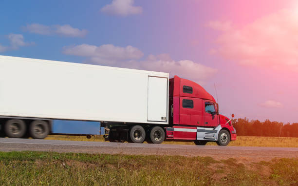 istock Large semi-trailer moves on a country road 1188993838