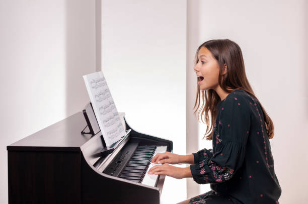 Girl playing the piano, she is very happy, Girl playing the piano, she is very happy, girl playing piano stock pictures, royalty-free photos & images
