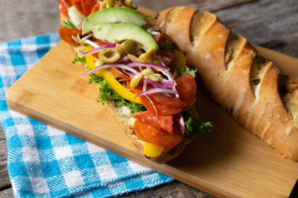 istock Salami sub sandwich in rustic baguette with olives and sprouts 1188994909
