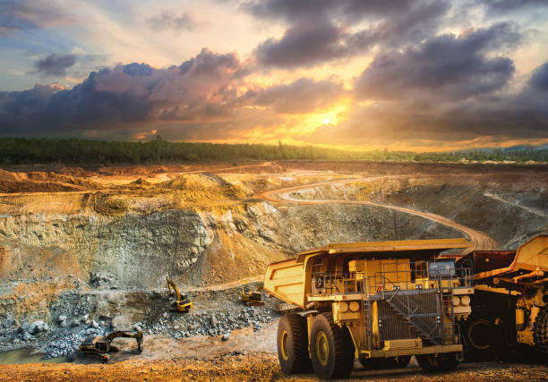 Mining Yellow dump truck loading minerals copper, silver, gold, and other  at mining quarry. mining equipment stock pictures, royalty-free photos & images