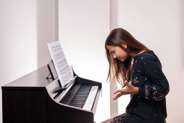istock Girl learning piano, she is sad, 1188996860