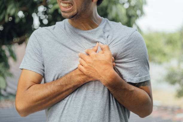 Young man with chest pain suffering, health care concept stock photo