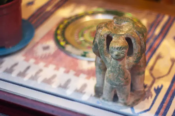 mexican figurine, little men holding a plate of ashtray. ancient civilization. decorative