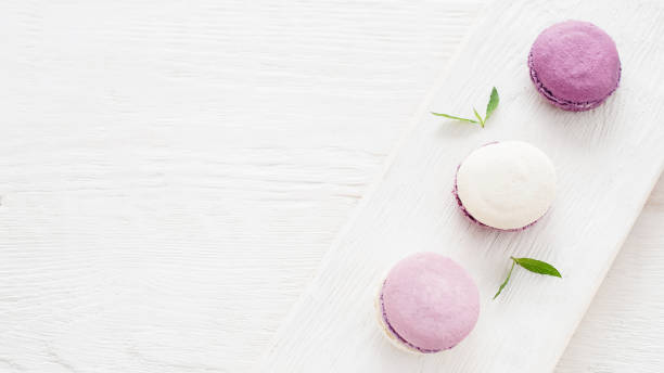istock french cookies purple macaroons white background 1189010265