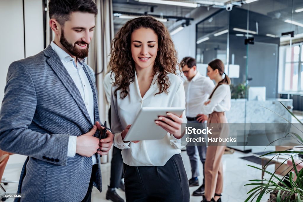 Business people having fun and chatting at workplace office Business Stock Photo