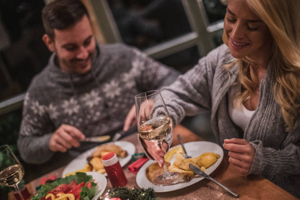 istock A handsome young couple having a candlelit dinner on Christmas eve. 1189010427