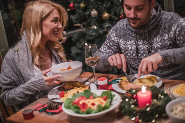istock A handsome young couple having a candlelit dinner on Christmas eve. 1189010430