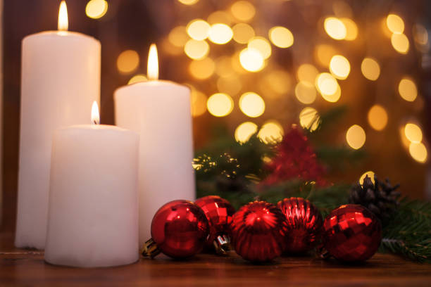 Tree branches, cones, bokeh lights, candles. Christmas balls. Preparation for the New year and Christmas
