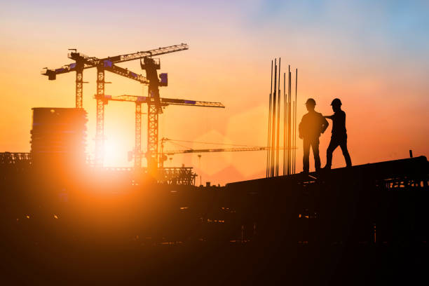 istock Silhouette of engineer and construction team working at site over blurred background for industry background with Light fair.Create from multiple reference images together 1189010881