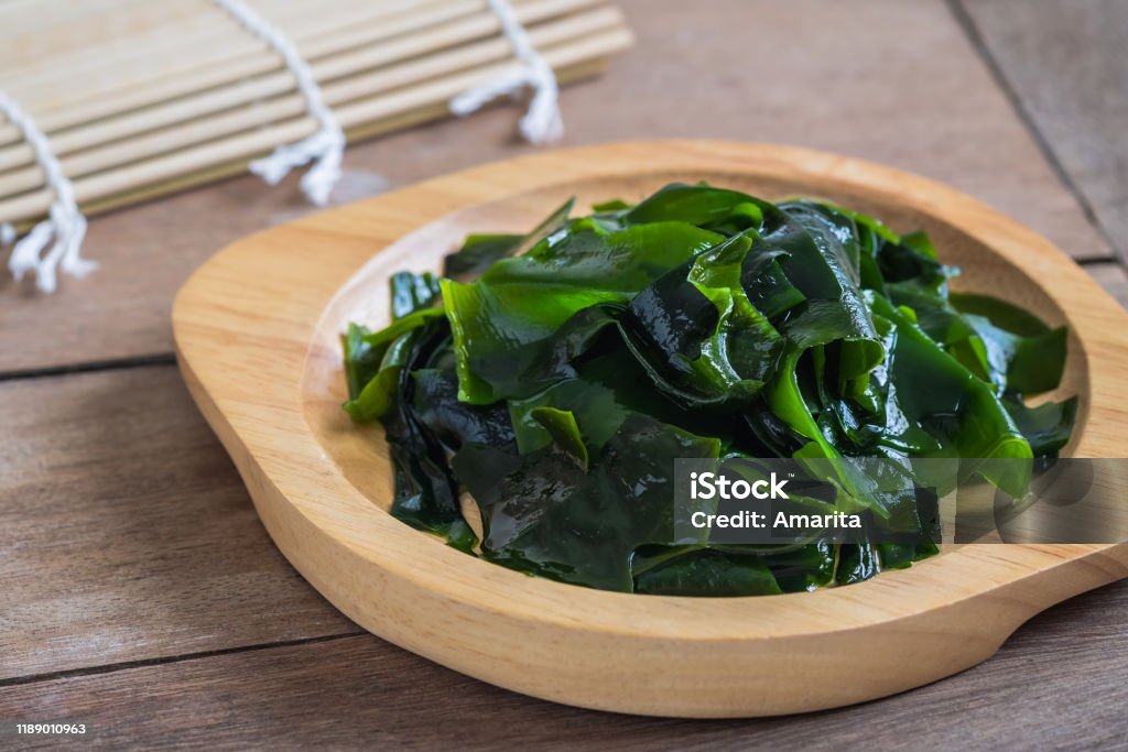 Wakame seaweed on wooden plate Seaweed Stock Photo