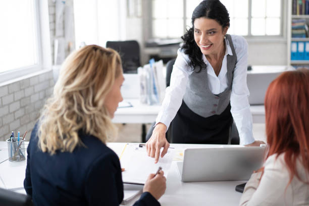 istock Agent talking to clients, signing agreement in office 1189012097