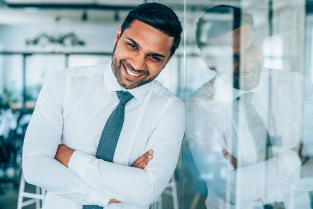 istock Smiling businessman in modern office. 1189012393