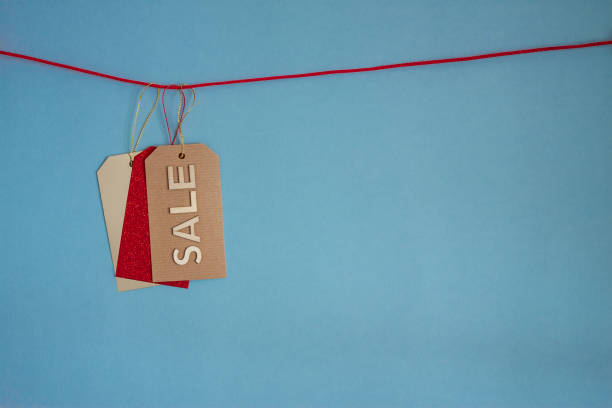 istock three colorful price tags on rope blue background 1189012636