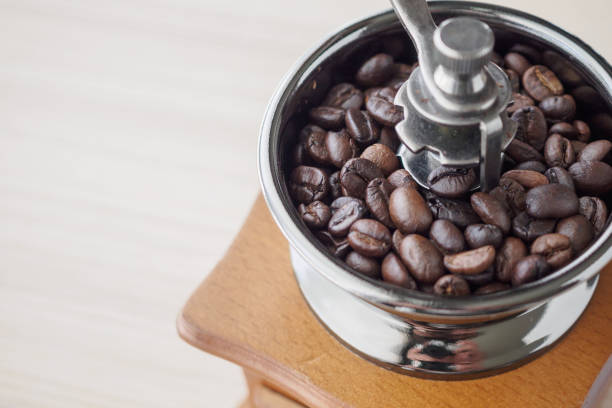 istock Vintage manual coffee grinder with roasted coffee beans 1189015310