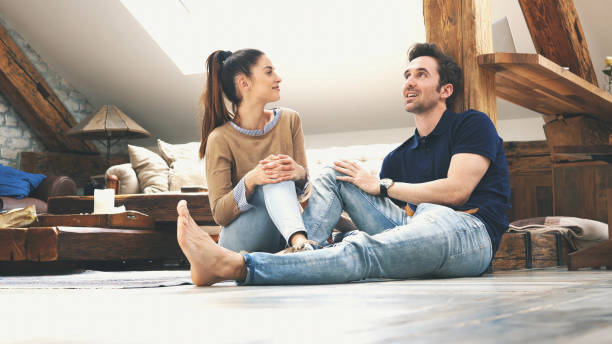 istock happy couple talking to each other at home 1189015735