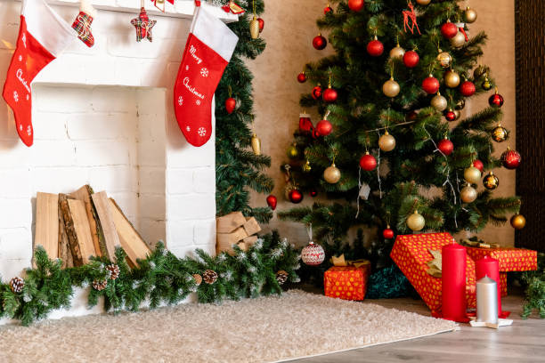 istock decorated white fireplace with socks and Christmas tree with gifts 1189016457