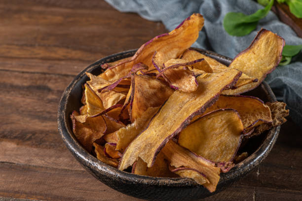 istock Delicious sweet potato chips in bowl,  on table 1189020900