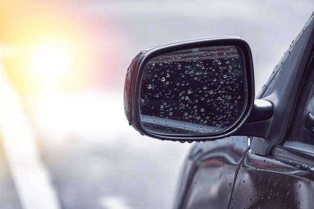 istock close up of water droplets on the car side mirror after rain with copy space, causing danger while using the car 1189024687