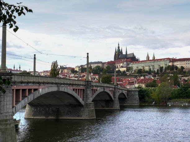 istock a tour boat passes under manes bridge in prague 1189029713