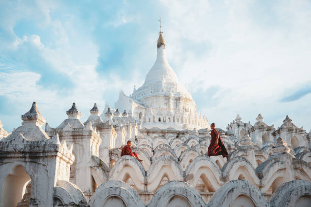 istock Novices under umbrellas at historic temple 1189030893