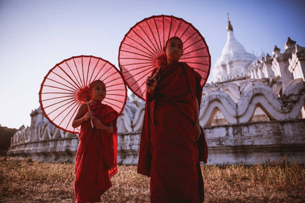 istock Novices under umbrellas at historic temple 1189030919