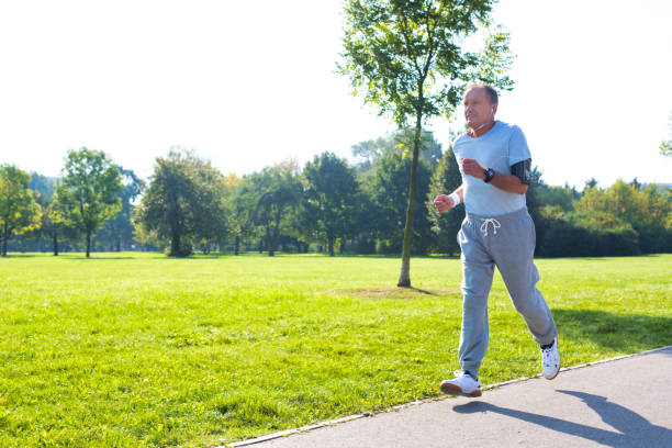 istock Active senior man running in park 1189048697